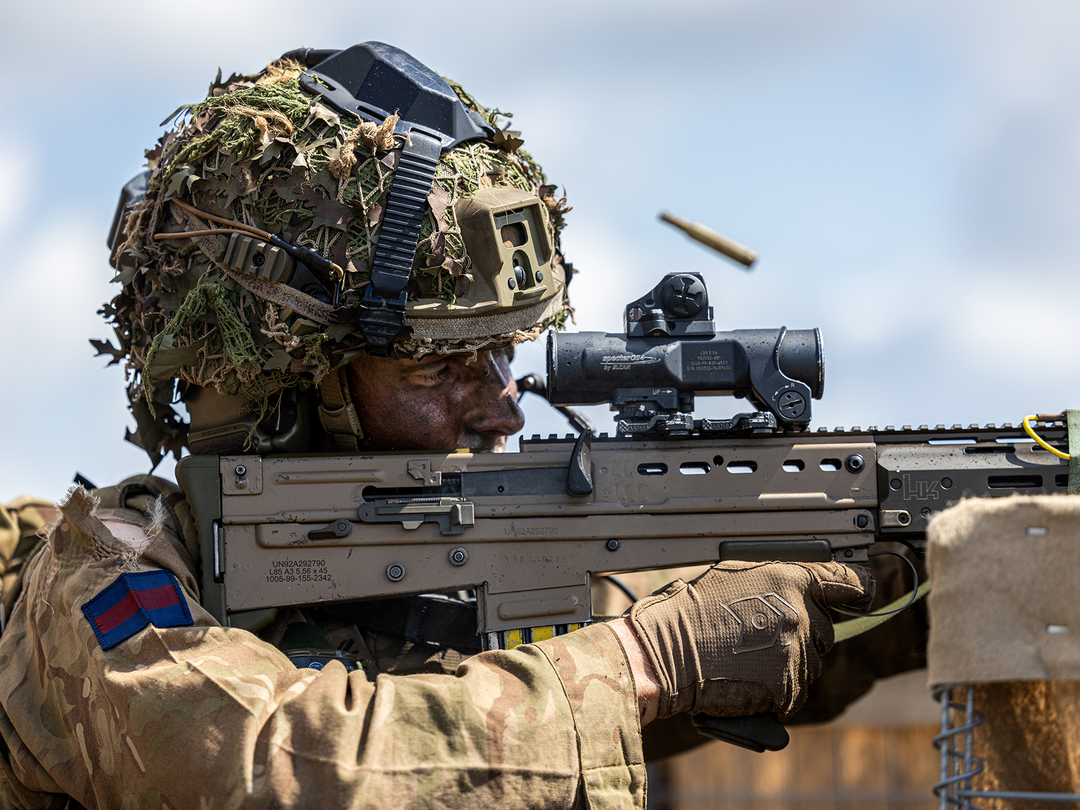 A British Army soldier firing his rifle