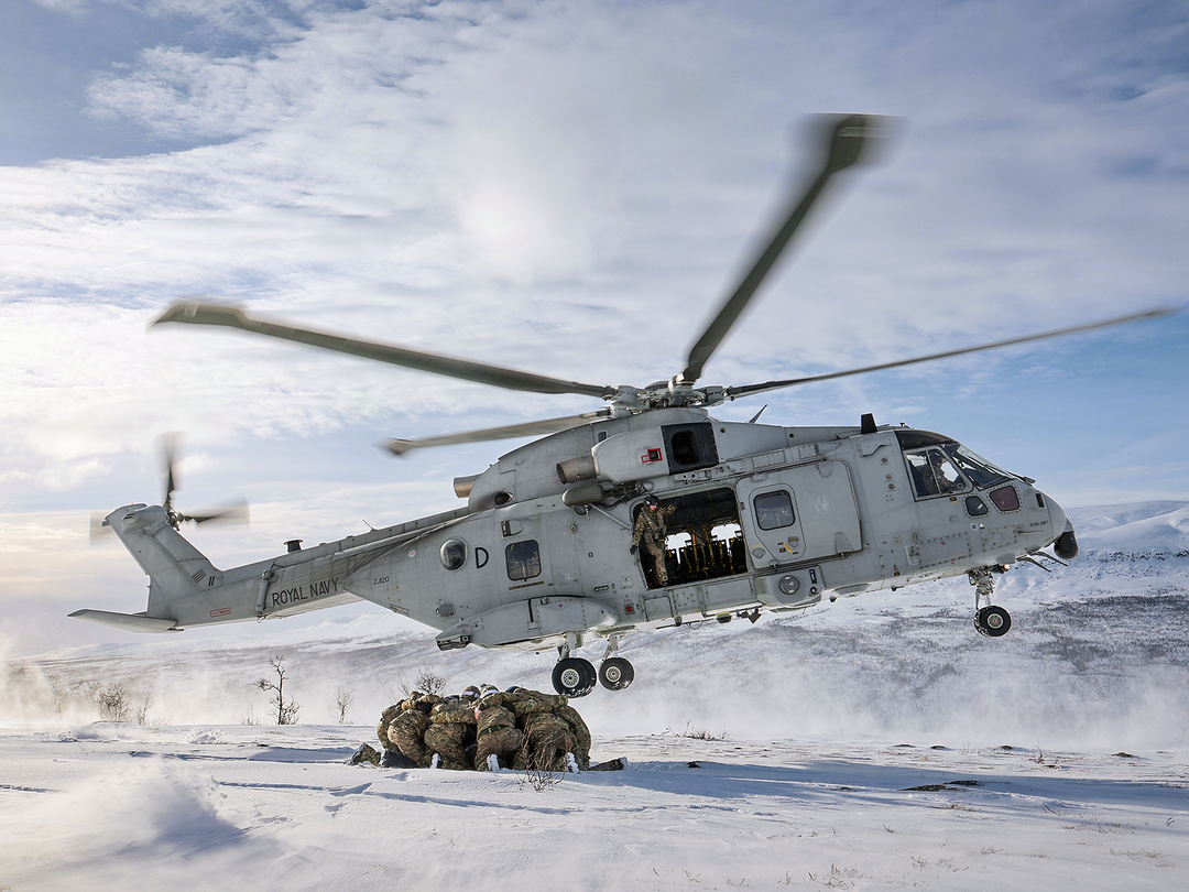 A merlin helicopter lands in the snow 